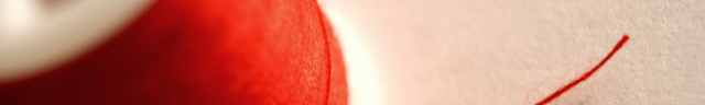 A cropped photo of a stray thread of red string